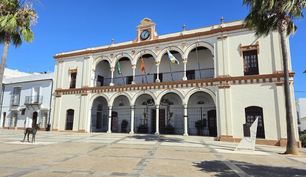 The whitewashed town hall of Moguer with its arcaded facade on a sunny square