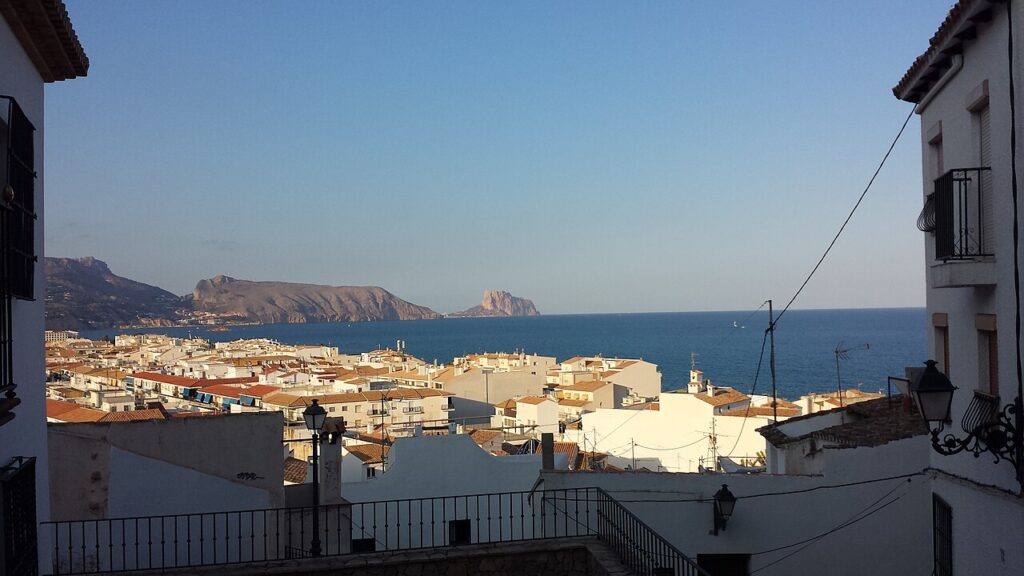 View over the rooftops of Altea to the sea and the distant Peñón de Ifach
