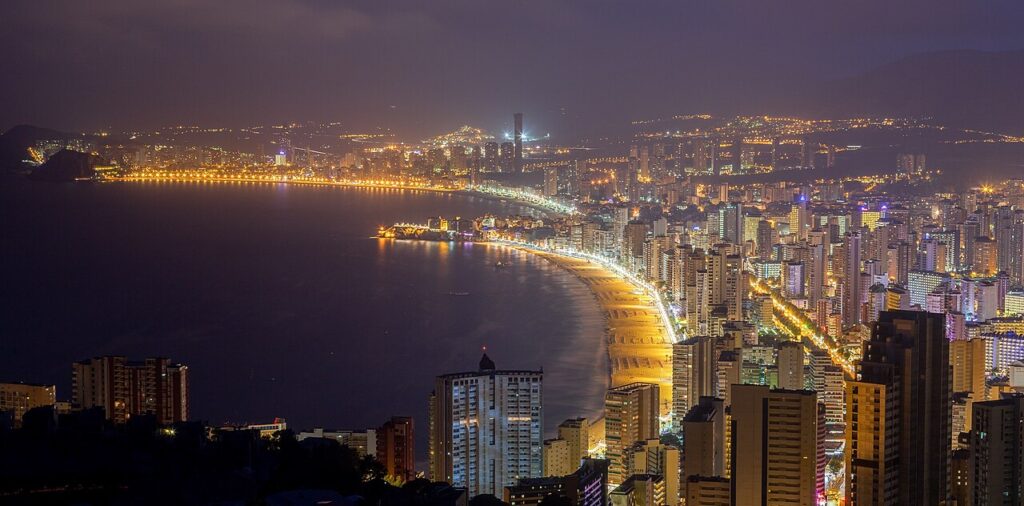 Benidorm skyline and its two bays glittering with lights at dusk