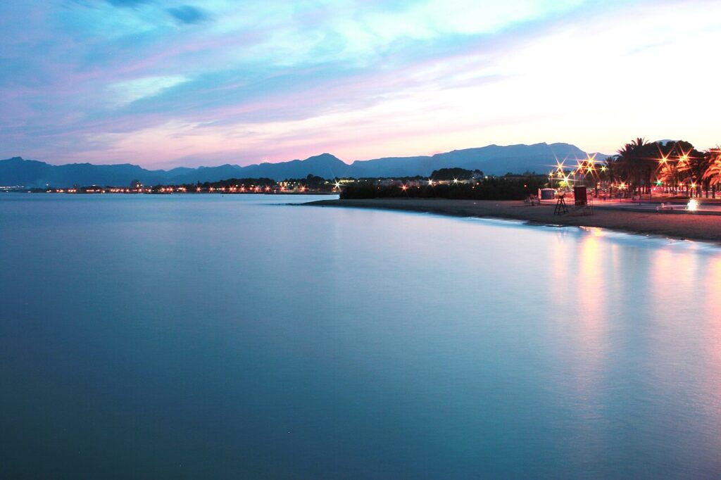Calm sea and the lights of the Cambrils waterfront at blue hour