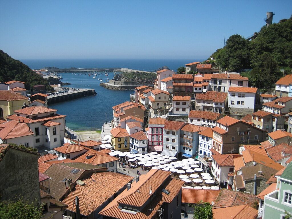Painted houses rising in tiers above the harbour at Cudillero, Asturias