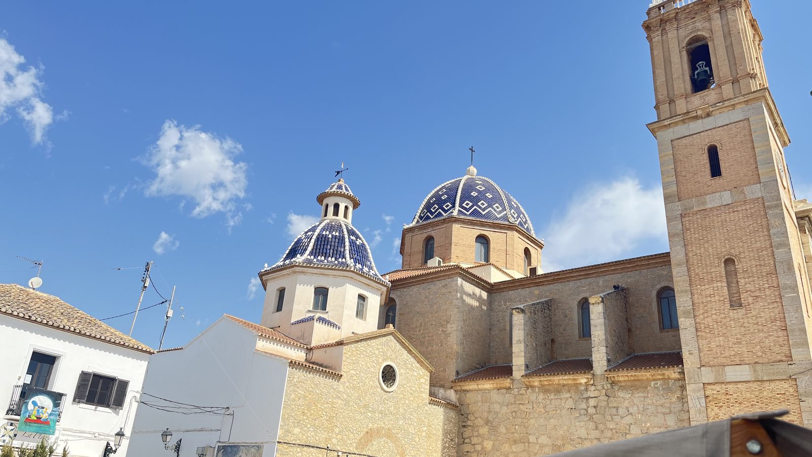 The blue-and-white glazed tile domes of the church of Nuestra Señora del Consuelo above the old town of Altea