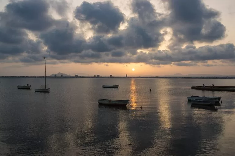 Small boats on the Mar Menor under a cloudy sunset