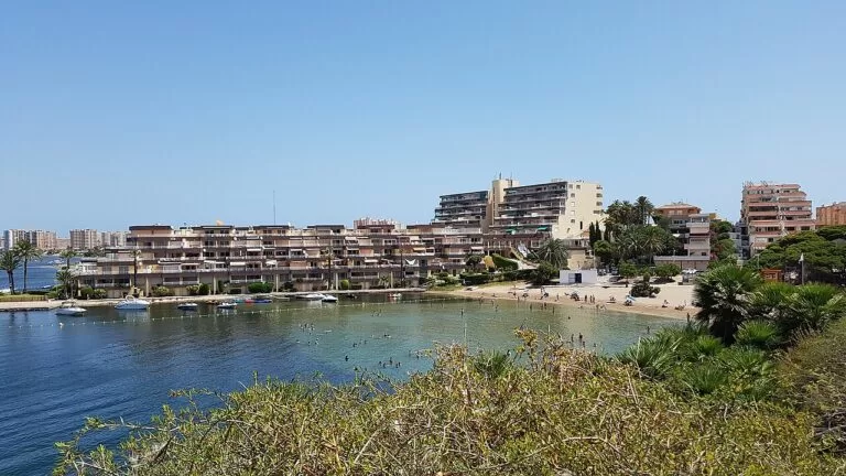 Apartment buildings around the sheltered lagoon cove of Cala del Pino in La Manga