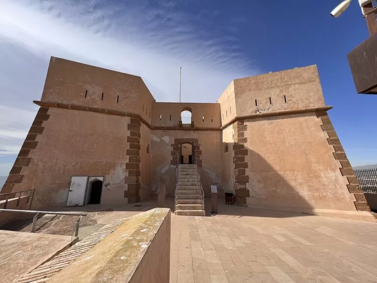 The sandstone walls and gate of the Castillo de San Juan de las Águilas