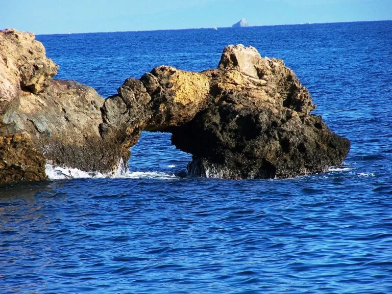A natural rock arch in deep blue water near Cabo de Palos