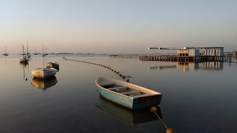 Rowing boats and a bathing pier on the calm Mar Menor at Santiago de la Ribera