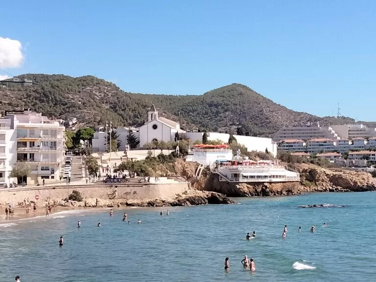 Sitges beach and the Sant Sebastia chapel with the Garraf hills behind