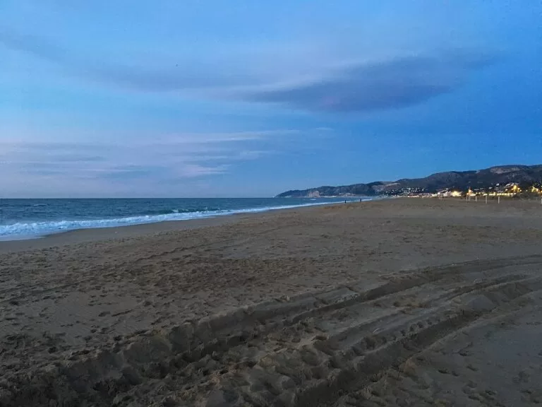 The long sandy beach of Castelldefels under a blue sky