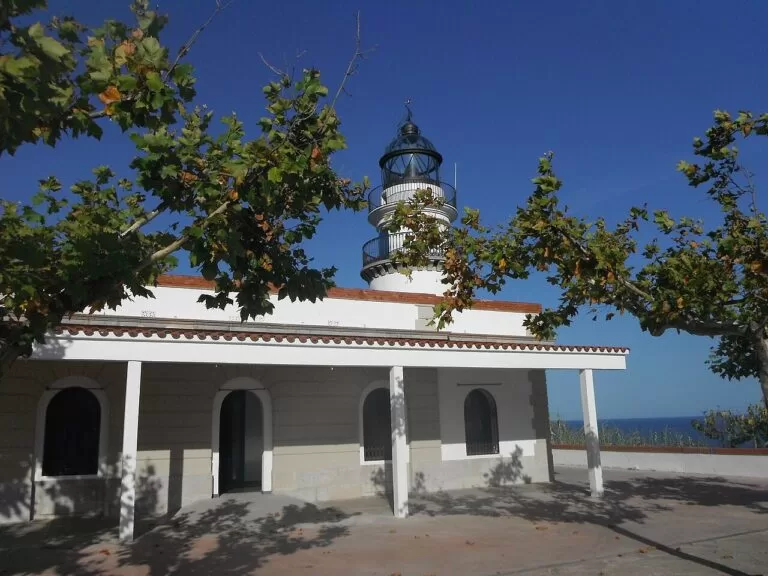 The white Calella lighthouse on its hill above the Maresme coast