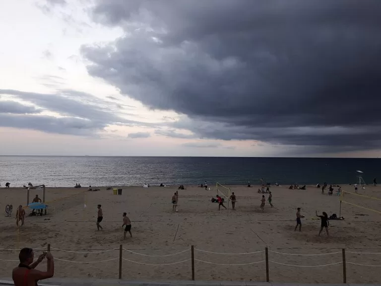 Storm clouds over the sand and sea at Bogatell beach