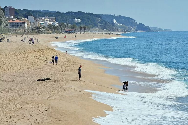 Waves rolling onto a sandy beach on the Maresme coast at Arenys de Mar