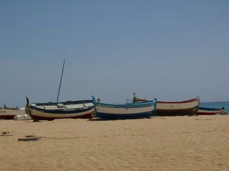Fishing boats pulled up on the sandy beach at Mataro
