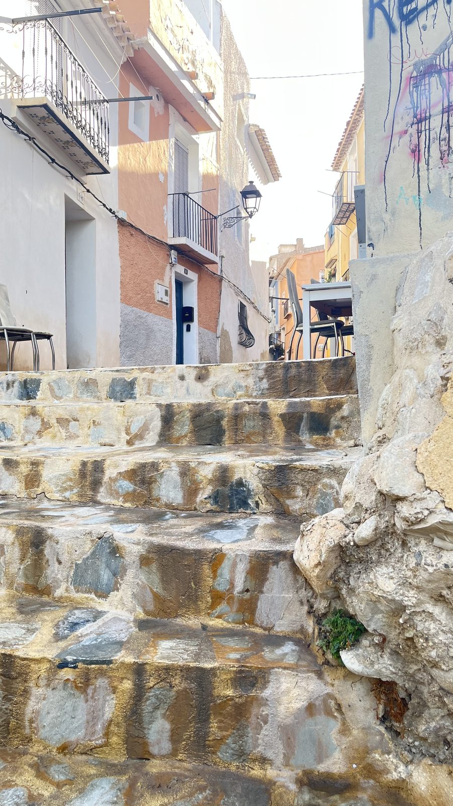 Stone steps climbing between painted houses in the old town of Villajoyosa